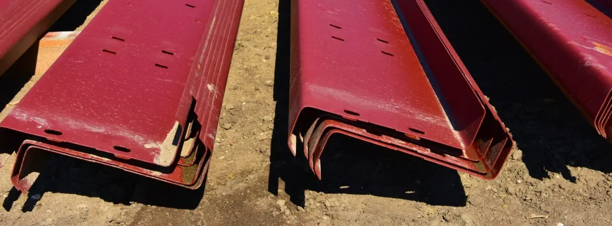 Red oxide C purlins, punched, stacked at the yard
